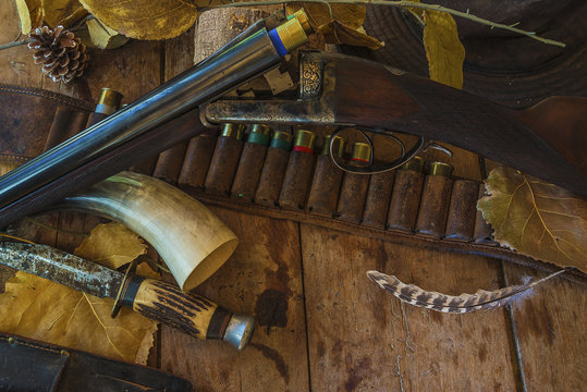 Hunting equipment and beautiful hunting rifle on old wooden background with copy space