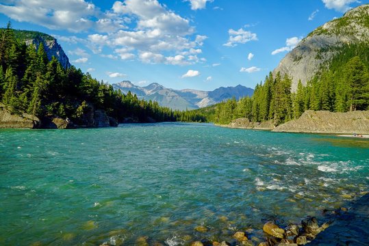 Beautiful Rocky Mountains and flowing water in Bow River in Banff, Alberta, Canada