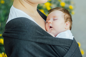 Infant baby sleeping in a wrap 