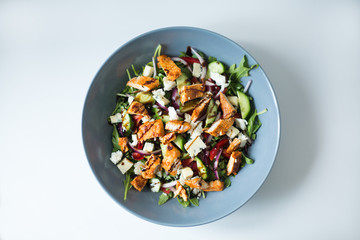 A healthy chicken salad in a grey bowl.