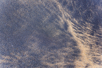 Black and white sand on the tropical beach of Sri Lanka