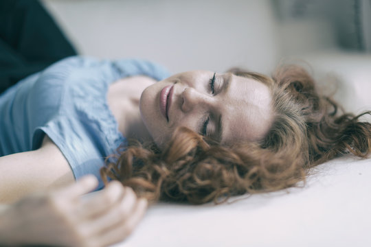 Young redheaded woman with sweet laugh