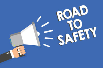 Text sign showing Road To Safety. Conceptual photo Secure travel protect yourself and others Warning Caution Man holding megaphone loudspeaker blue background message speaking loud.