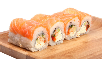tasty sushi roll on the wooden board background