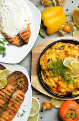 Two grilled salmon fish steaks with white cheese sauce and vegetables 
