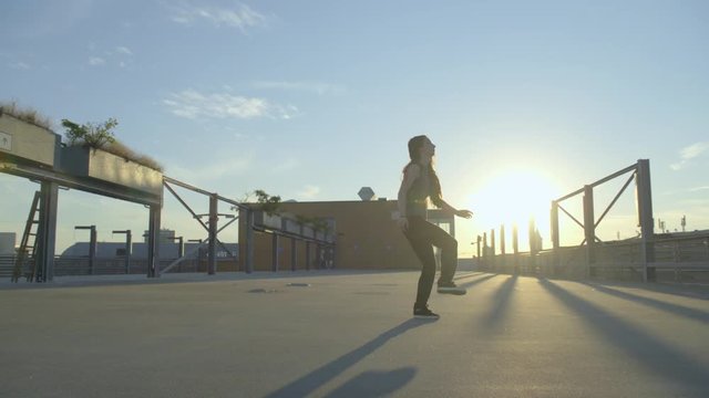  female dancer doing hip hop freestyle on a rooftop