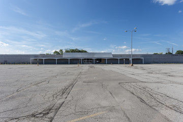 Large empty storefront and empty parking lot © Richard