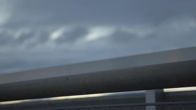 hip hop female dancer standing at the rooftop and watching, evening wind is moving her hair softly