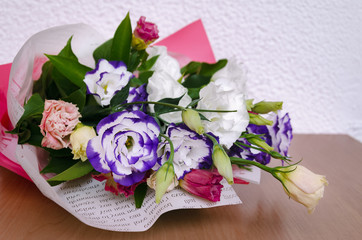 Eustoma in a beautiful bouquet with other flowers on the table for a holiday
