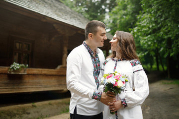  Beautiful bride and groom in the ukrainian style are standing w