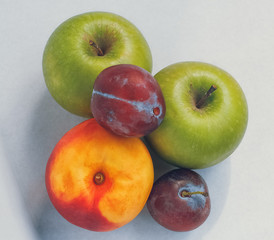 Set of fruits isolated on white background: two apples, two plums, one nectarine