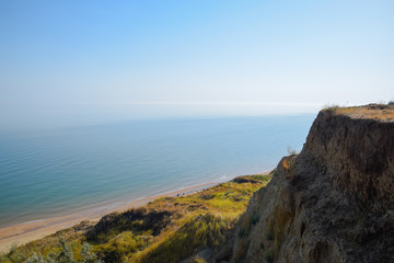 The hilly coast near the Sea of Azov. Clay rocks, a cliff on the shore.
