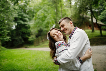  Beautiful bride and groom in the ukrainian style are standing w