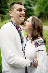 Fototapeta premium Beautiful bride and groom in the ukrainian style are standing w
