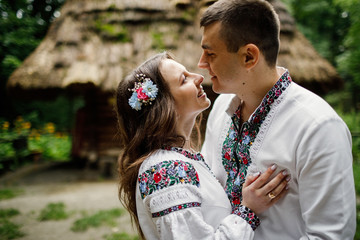  Beautiful bride and groom in the ukrainian style are standing w