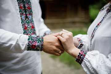  Beautiful bride and groom in the ukrainian style are standing w