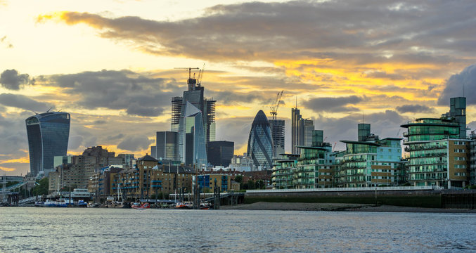 London skyline at sunset including skyscrapers at financial district. Picture took along the riverside.