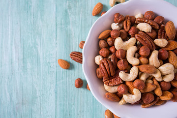 mixed nuts on wooden surface