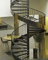 Fotobehang Trappen Architecture of spiral staircase and table, contemporary design  © William