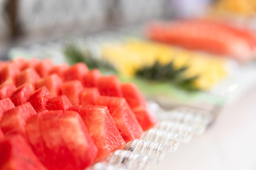 stack of sliced watermelon on tray at hotel buffet line