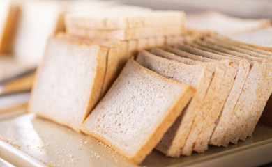 stack of sliced white bread on tray at hotel buffet line