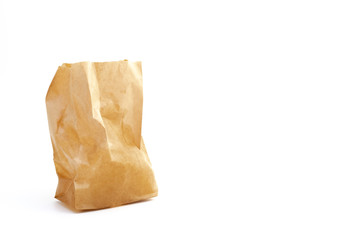 crumpled brown paper bag on white background, copy space on right.