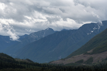 Fototapeta na wymiar Heavy rain moves across a dramatic valley in the Canadian wilderness