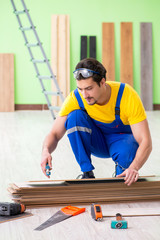 Professional contractor laying flooring at home