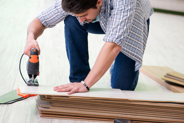 Man laying flooring at home