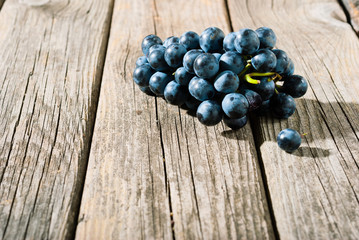 red grapes on old weathered wooden table