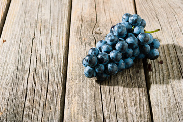 red grapes on old weathered wooden table