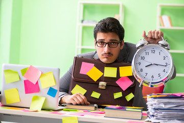 Businessman unhappy with many conflicting priorities sitting in 