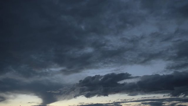 Slow moving dramatic clouds in sunset