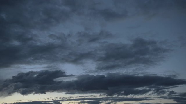 Pan over a dramatic dark sunset sky 