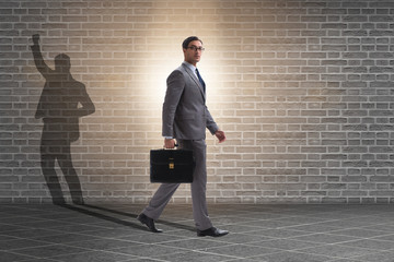 Businessman and his shadow in business concept