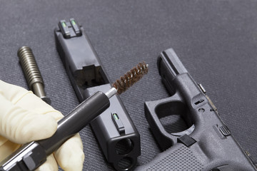 Using a wire brush to Clean a Hand Gun