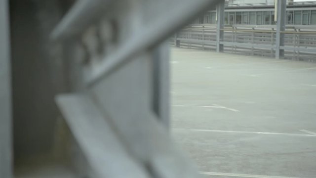 Hip hop girl with a hoody walks very cool by on a concrete pier