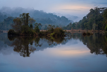 Lake in the forest at sunset. Smoothing the surface with reflection