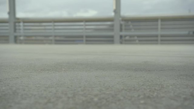 A Hoody is falling on a grey concrete floor