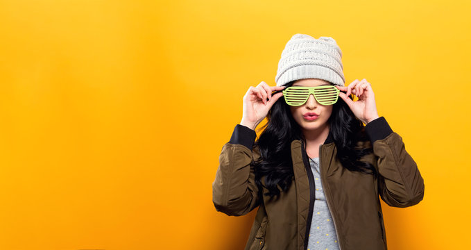 Fashionable Woman With Attitude In Bomber Jacket On A Golden Yellow Background