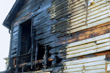 Fire line in front of a destroyed home. burnt house after fire
