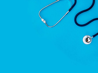 stethoscope on blue background copy space