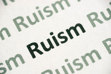word Ruism printed on paper macro