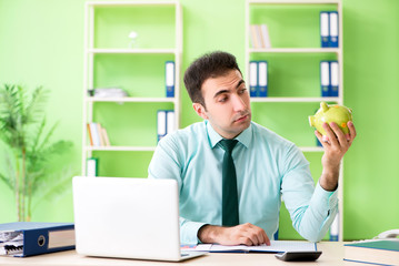 Naklejka premium Male financial manager working in the office 