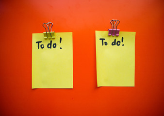 Сolorful blank sticky note or empty post notes with office clamps on red background