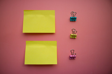 Сolorful blank sticky note or empty post notes with office clamps on pink background