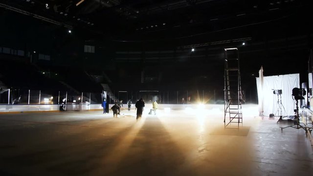 timelapse people prepare concert equipment among ice arena