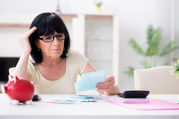 Mature woman trying to reconcile her bills