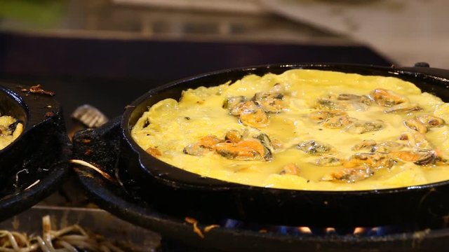 Frying  oyster omelette in pan, Thai street food