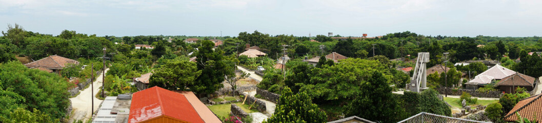 Obraz premium Panoramic view of residential area of Taketomi Island in Okinawa, Japan. (竹富島 集落 パノラマ写真)